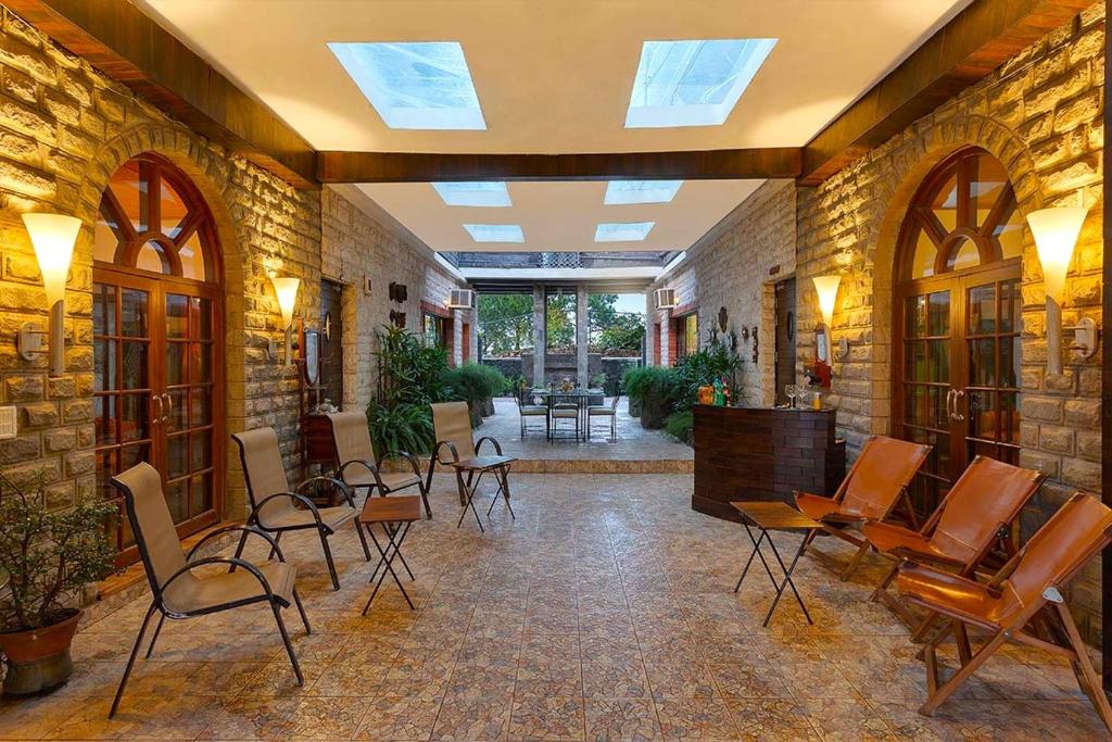 a room with chairs and tables in a building at Mistair 5BR Private Villa Cook Staff Pool Table in Kasauli
