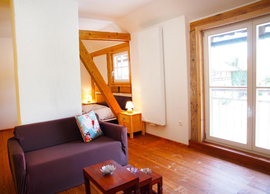 a living room with a couch and a table at Schlossgut Franken - Doppelzimmer Schlossblick in Redwitz an der Rodach