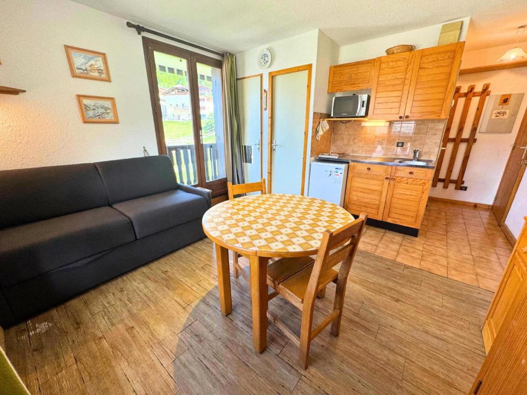 a living room with a table and a couch at Résidence Biolley 1 - Studio pour 2 personnes dans le centre du village MAE-4274 in Saint-Martin-de-Belleville
