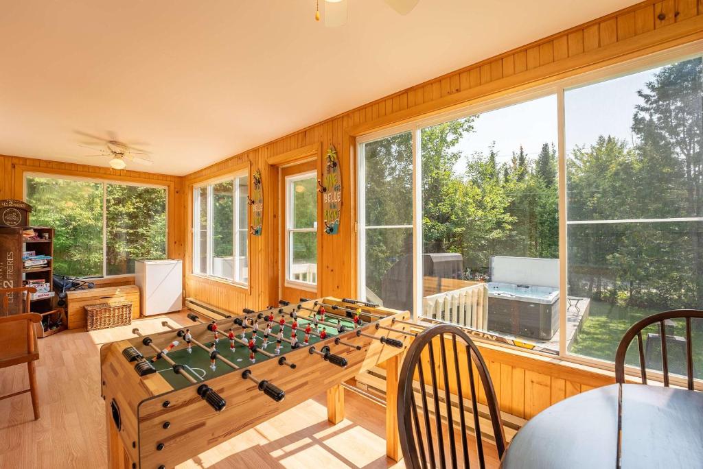 a large room with a table with a chessboard on it at Spa - Babyfoot - Le Panache in Entrelacs