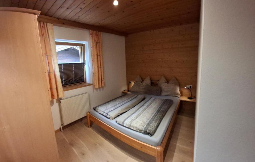 a bedroom with a bed in a room with a window at Ferienwohnung Frauenkogelblick mit Terrasse in Grossarl