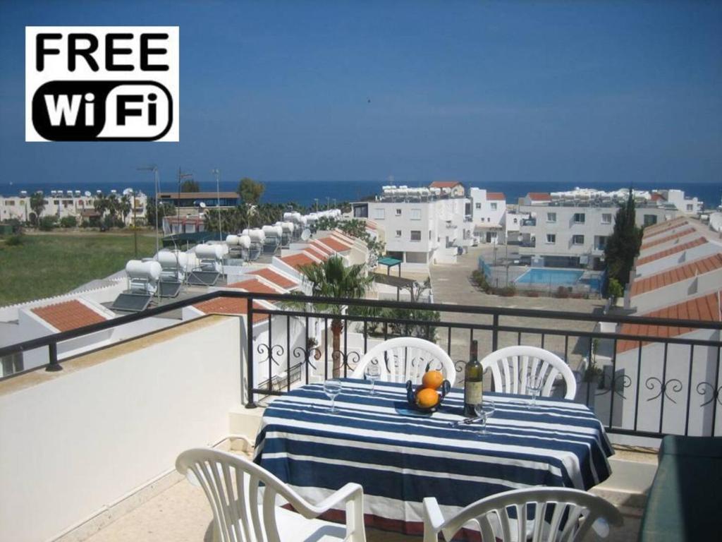 a table on a balcony with a view of the ocean at Penthouse Apartment Latchi Cyprus in Lachi