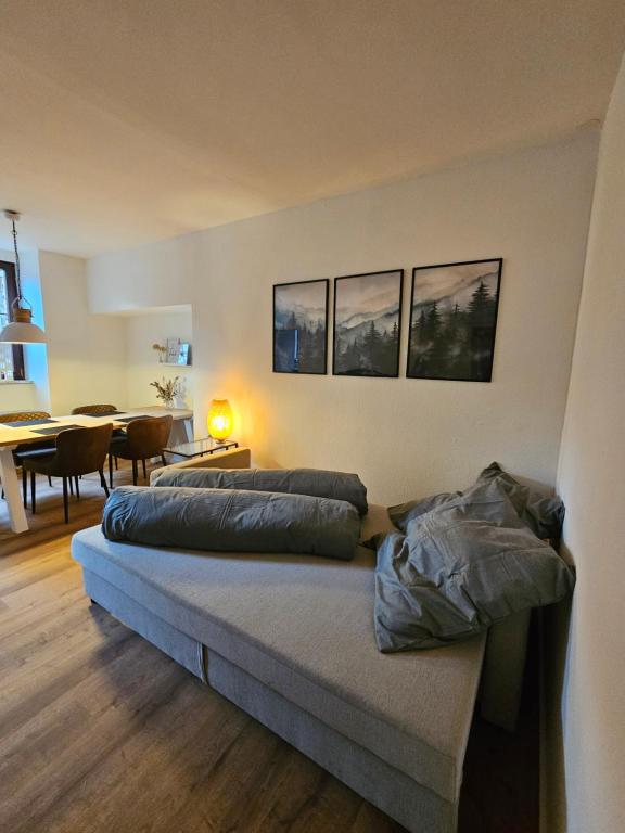 a bedroom with two beds and a dining room at Altes Pfarrhaus Amorbach in Amorbach