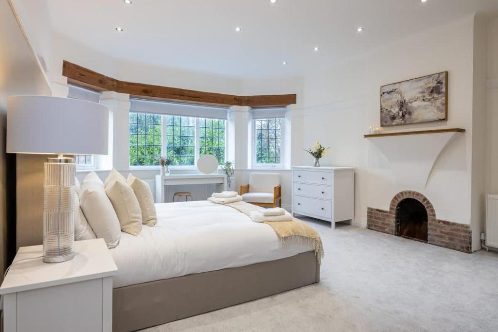 a bedroom with a large bed and a fireplace at The GreyStoke Mansion With Private Grounds in Hale