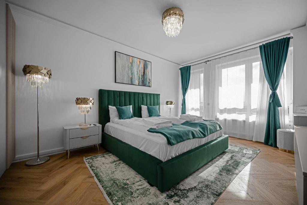 a bedroom with a green bed with a rug at FLH - Panoramic Garden Luxury Apt in Cristian