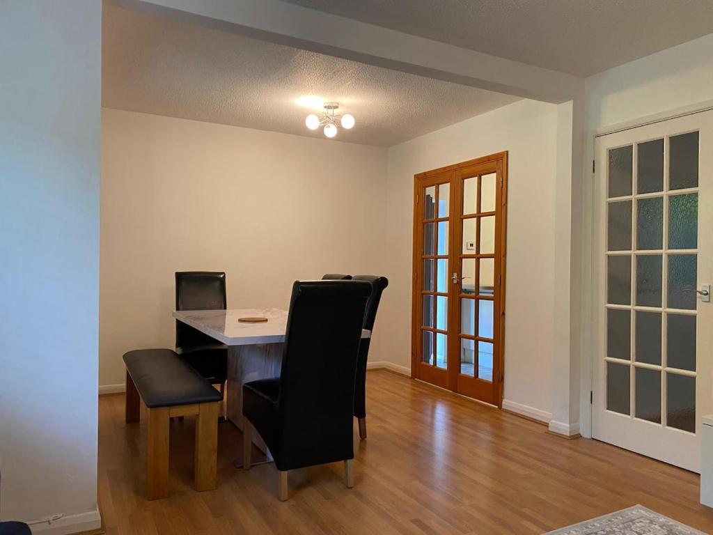 a dining room with a table and chairs at 3BR House Self Check In Parking By PlushPad in Shenley Lodge