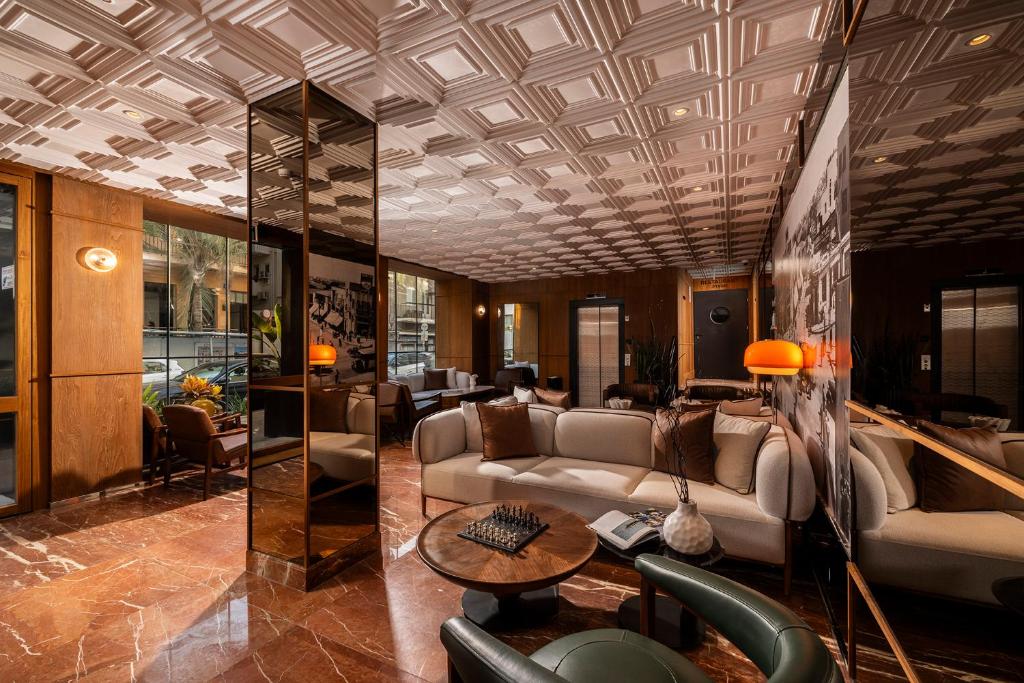 a lobby with couches and a table in a building at Hotel 1935- By Adam Hotels in Tel Aviv