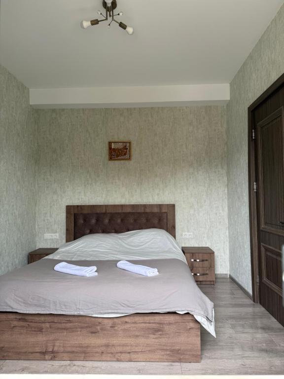 a bedroom with a bed with two towels on it at Bakuriani, Trialeti Residence in Bakuriani