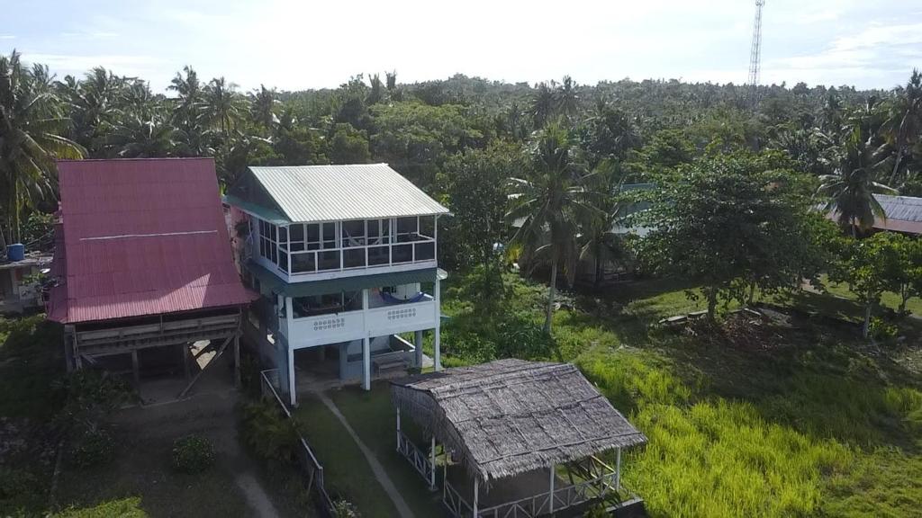 an aerial view of a house in a forest at Nias Surf Stay in Lagudri