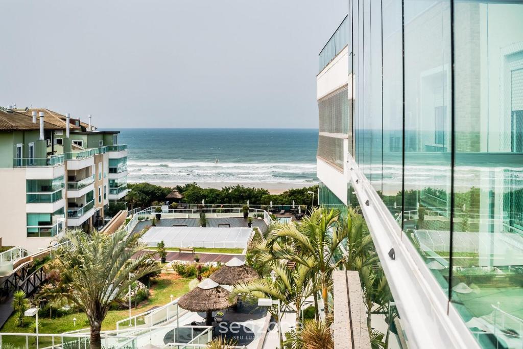 a view of the ocean from the balcony of a building at Apto beira mar com vista Praia do Santinho ASR204 in Florianópolis