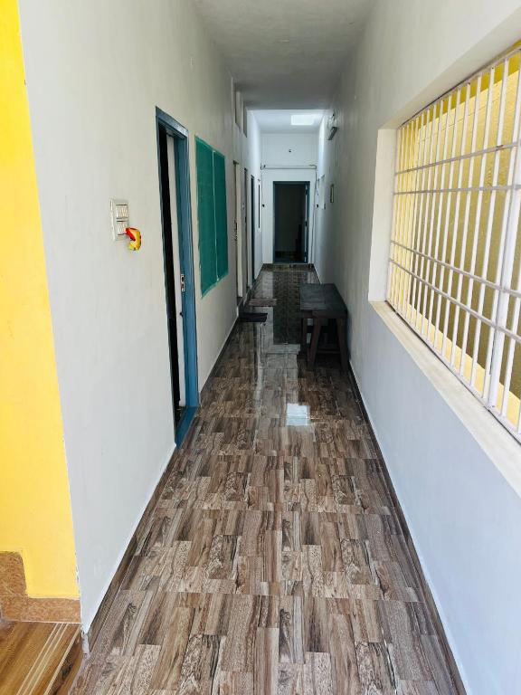 a hallway of a building with a wooden floor at THEE Confort rooms in Pondicherry
