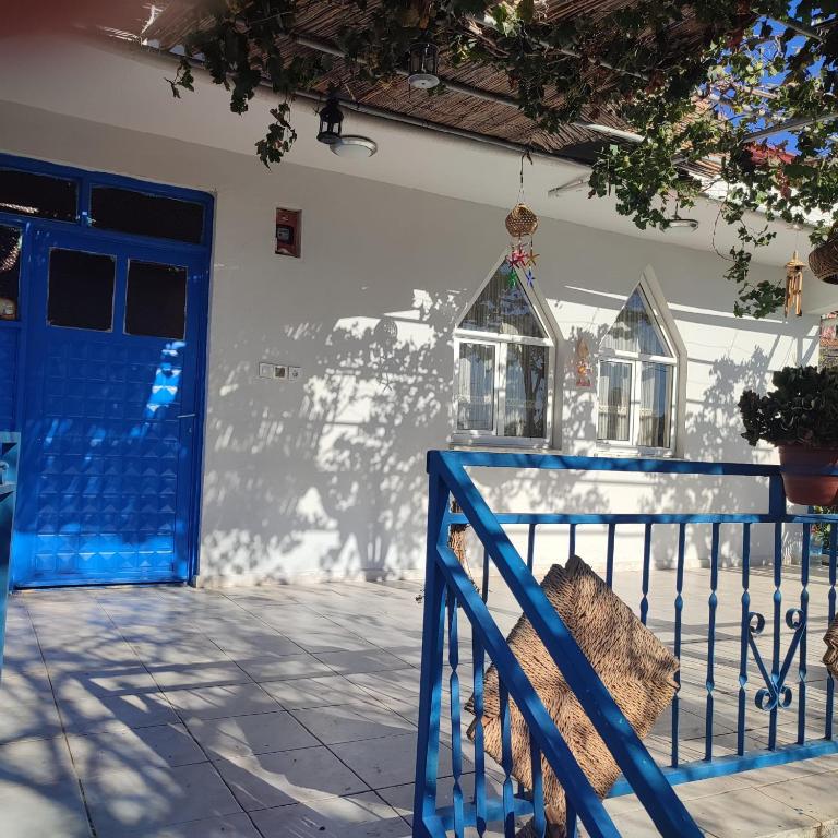 a blue door of a house with a fence at ÇETİN HoME in Eskiömerler