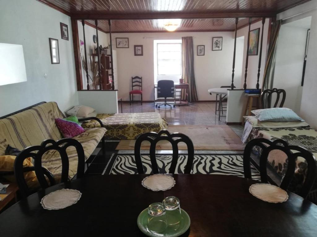 Santa LuziaにあるQuinta das Palmeiras, Room 1のソファとテーブルと椅子のあるリビングルーム