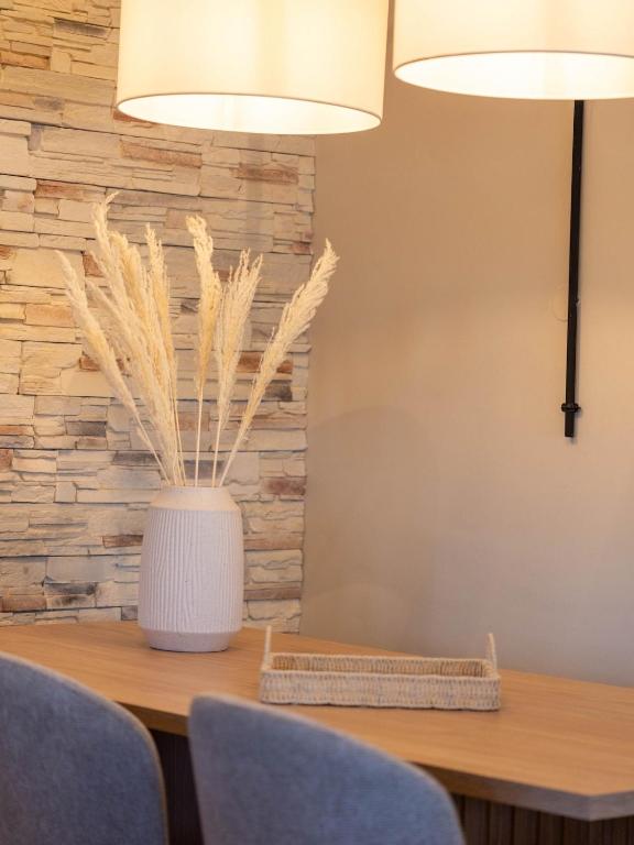 a dining room table with two chairs and two lamps at Villa Alia in Makri