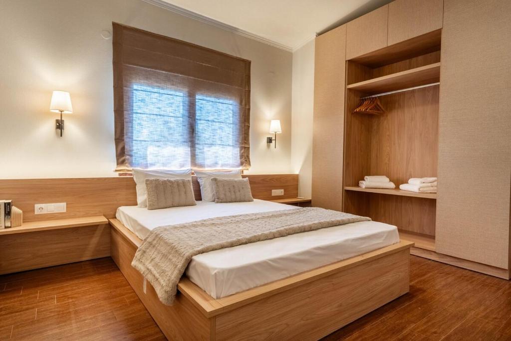 a bedroom with a large bed and a window at Villa Alia in Mákri