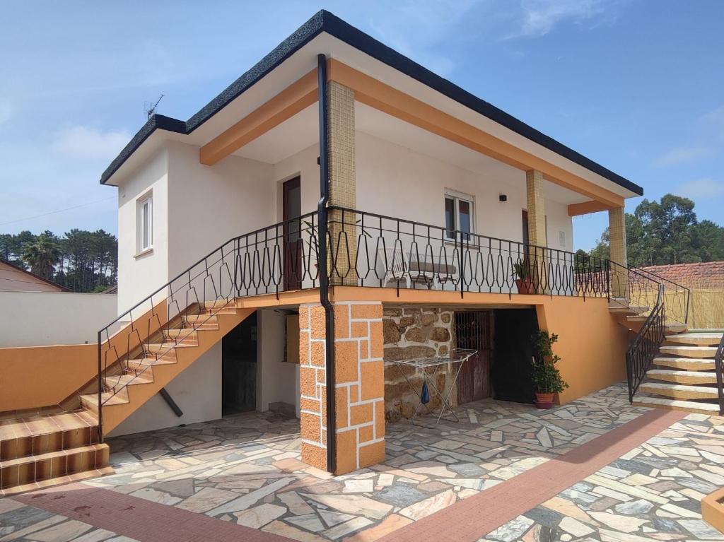 a house with a balcony and a staircase at Marca 34 in Monção