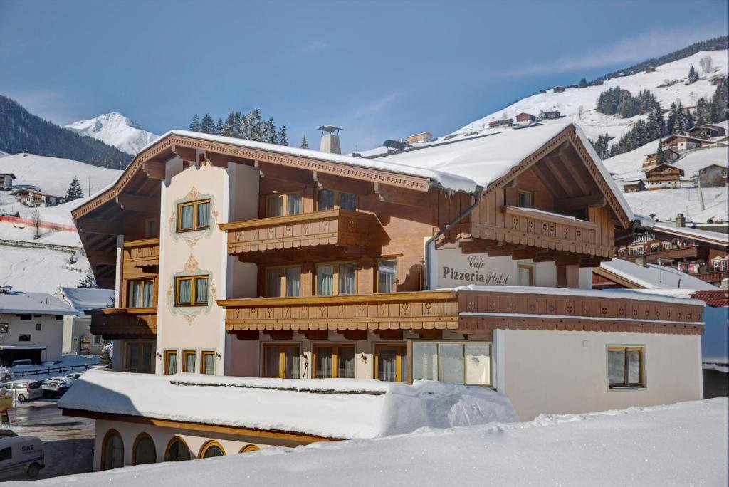 a building on top of a snow covered mountain at Aparthotel Dorfplatzl Garni Apartments & B&B in Tux
