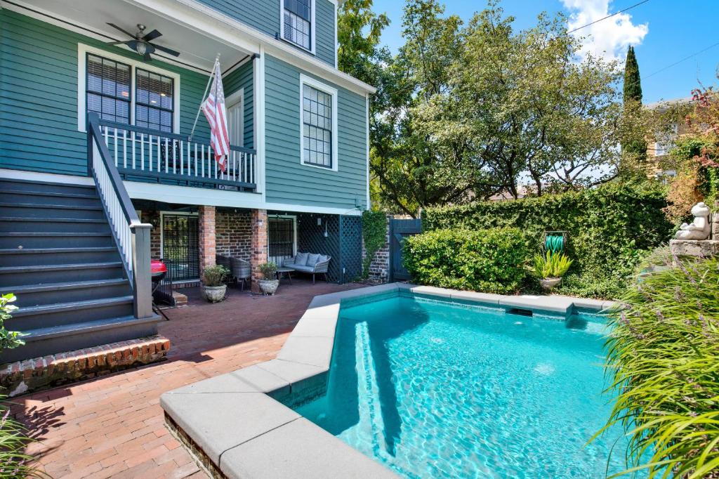 a swimming pool in front of a house at Mint Julep Estate in Savannah