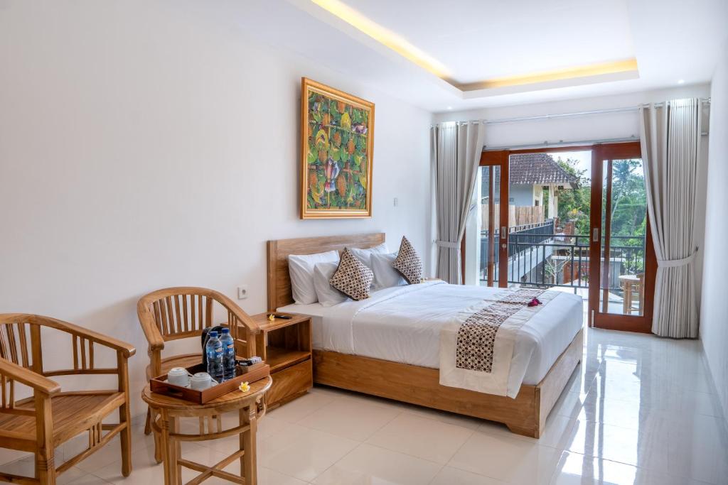 Ένα ή περισσότερα κρεβάτια σε δωμάτιο στο Graha Dwarkavati Ubud
