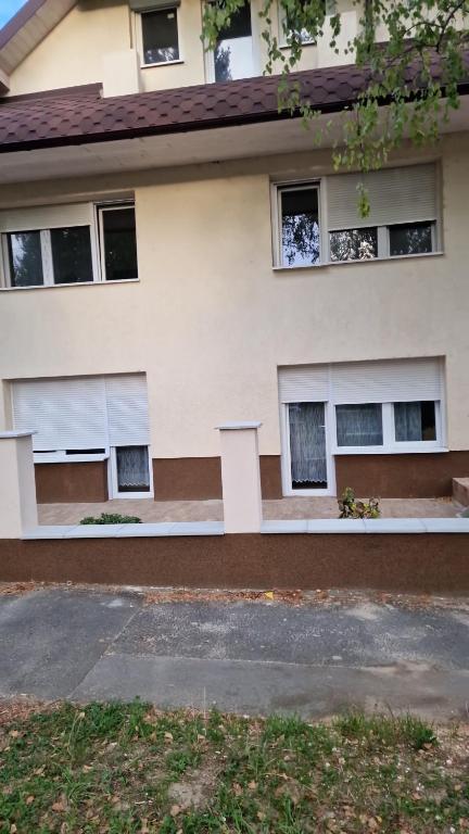 a white building with windows on the side of it at Villa Olga in Hévíz