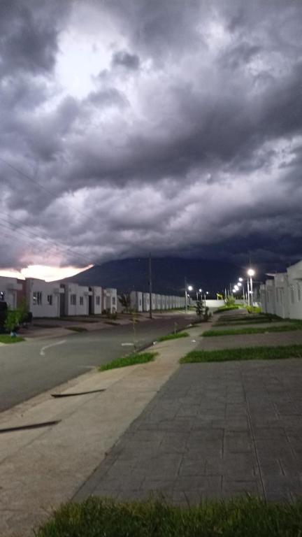 an empty street under a cloudy sky with buildings at la casita de Daniela in San Miguel