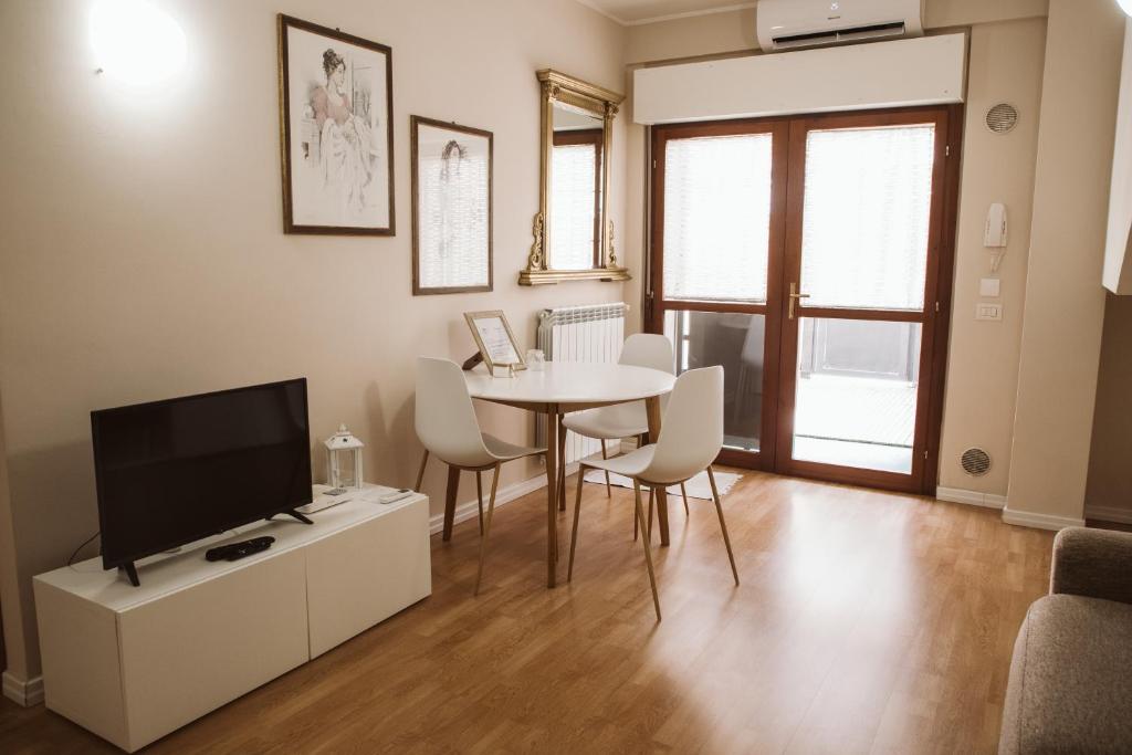 a living room with a television and a table and chairs at as maison in Terni