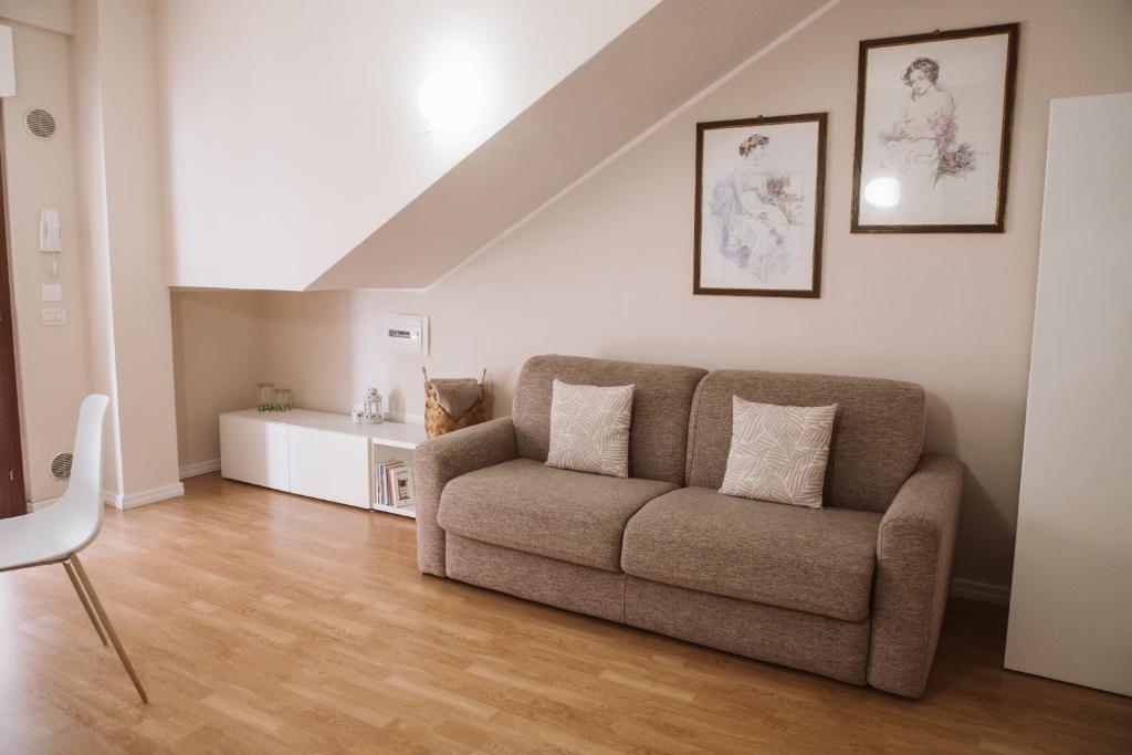 a living room with a couch and a table at as maison in Terni