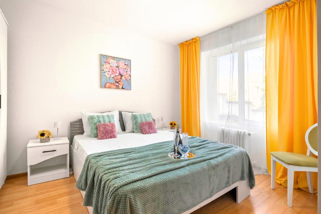 a bedroom with a bed with a green blanket at Stepup Apartment, Downtown Bucharest, City Center, Garden View in Bucharest