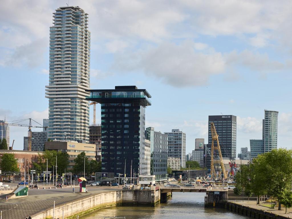 a city skyline with tall buildings and a river at DoubleTree by Hilton Rotterdam Centre in Rotterdam