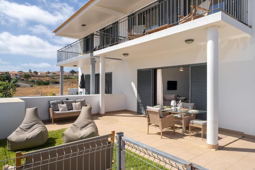 einen Balkon mit einem Tisch und Stühlen auf einem Haus in der Unterkunft MarAnteMar Refuge between Sea and Tranquillity in Pontinhas