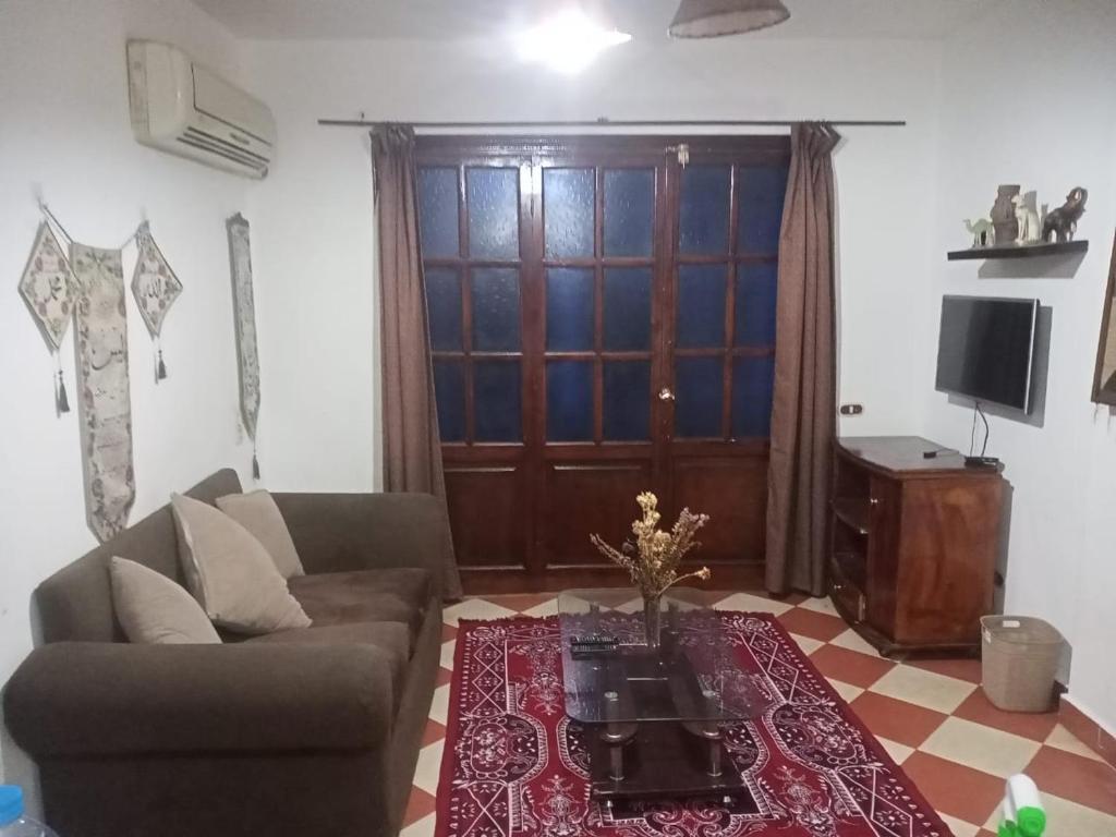 a living room with a couch and a coffee table at Riviera Apartment in Sharm El Sheikh