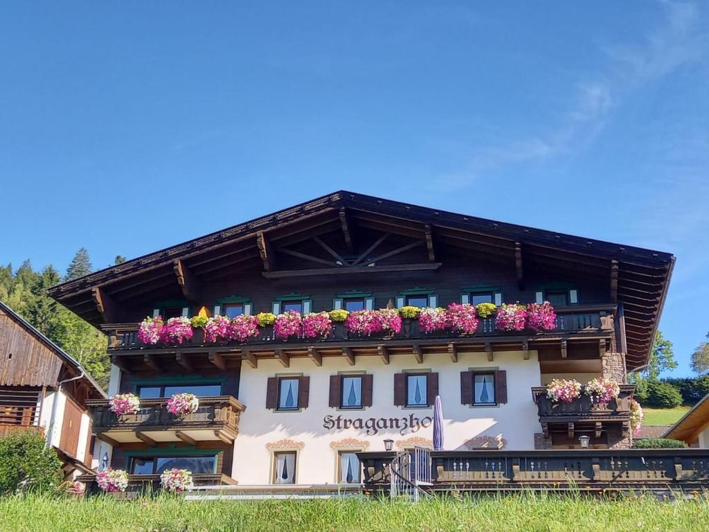 a building with flower boxes on it at Straganzhof in Iselsberg