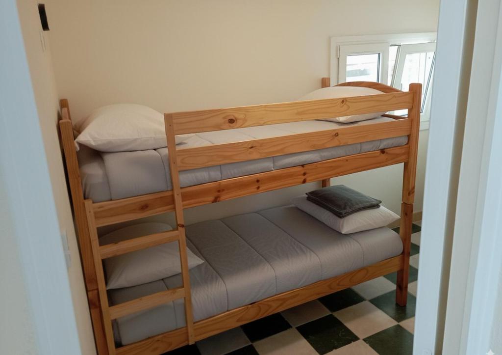 a couple of bunk beds in a room at Votre cocon à 1km de la plage in Camiers