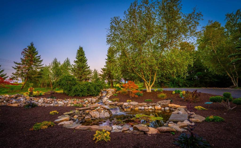 a garden with a pond in the middle at Welcome to the Lodge! Little Falls NY in Little Falls