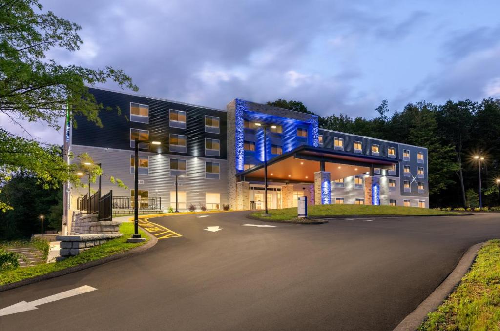 a building with blue lights on the side of it at Holiday Inn Express & Suites Pittsfield-Lenox-Berkshires by IHG in Pittsfield
