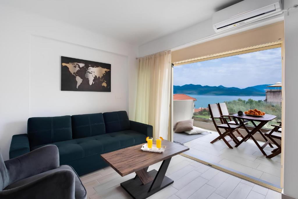 a living room with a couch and a table at Melodia Lefkada apartment 5 in Nikiana