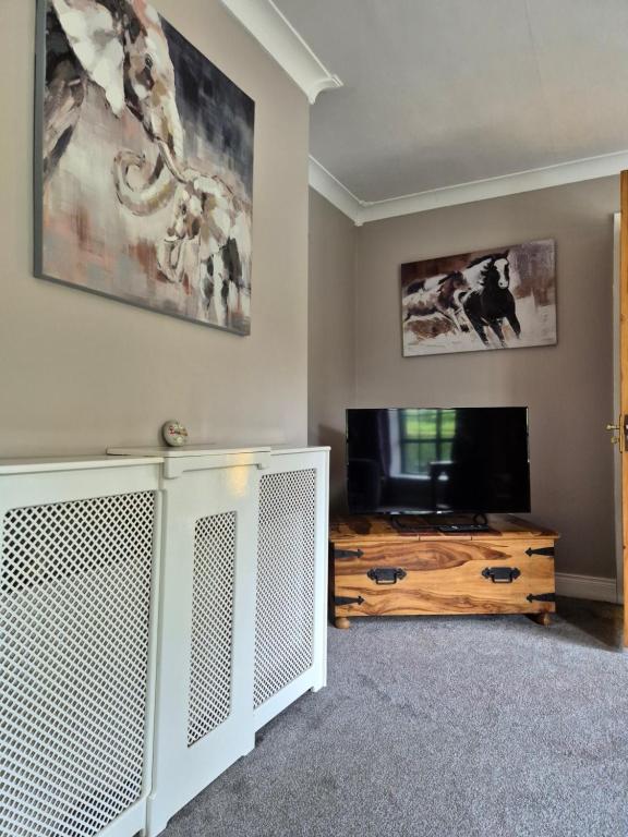a living room with a television and a table at Bungalow Bliss in Carlow