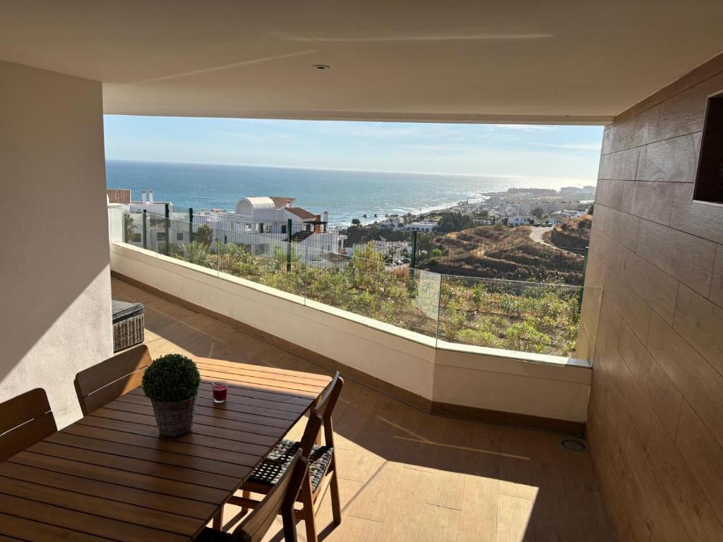 a room with a table and a large window at Isea & Sun Calaceite in Torrox Costa