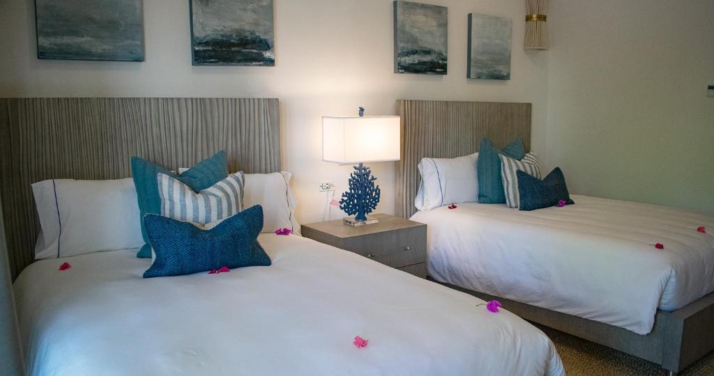 Un dormitorio con dos camas con almohadas azules y blancas. en Los Cabos Golf Resort, Trademark Collection by Wyndham, en Cabo San Lucas