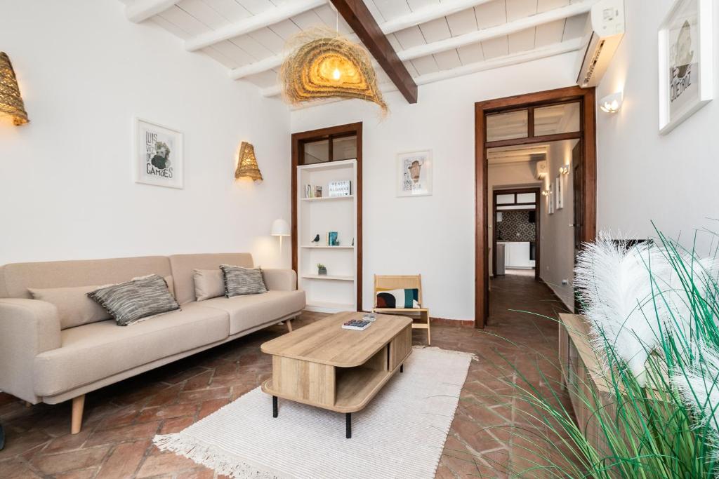 a living room with a couch and a coffee table at Casa das Letras by east ALgarve guest in Tavira