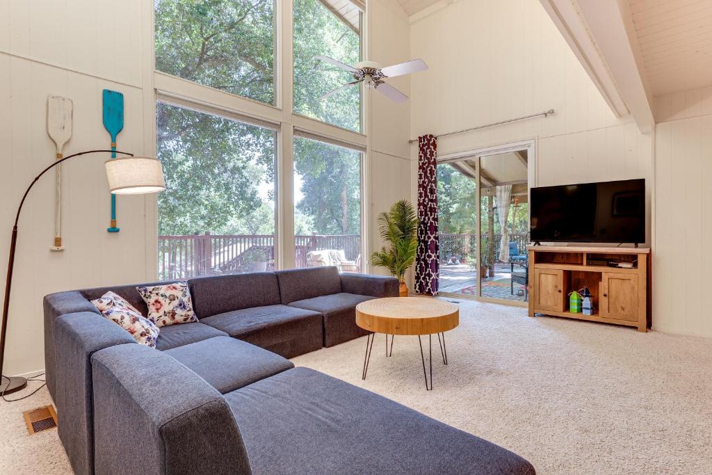 a living room with a blue couch and a tv at WFH-Friendly Retreat Less Than 1 Mi to Clear Lake! in Glenhaven