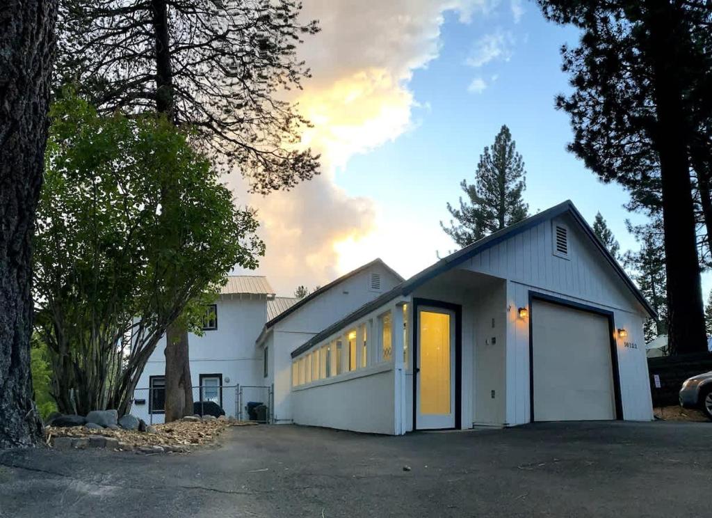 a large white building with a large garage at Family Friendly Charming Truckee Getaway Walk to Shops & Dining in Meadow Lake Park