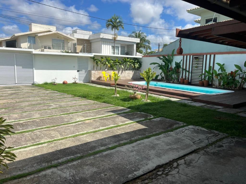 a backyard of a house with a swimming pool at CASA OUTEIRO da GLORIA in Porto Seguro