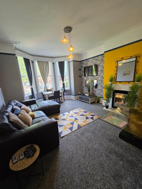 a living room with a couch and a fireplace at Charming - 8ight Havens in Folkestone