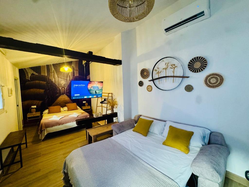a bedroom with a bed with yellow pillows on it at Loft Alegría de Jerez in Jerez de la Frontera