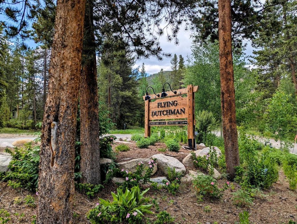 a sign for a hiking program in a forest at Flying Dutchman 1104 by SummitCove Lodging in Keystone