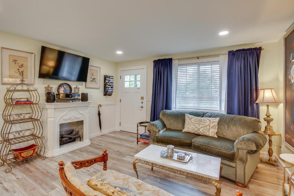 a living room with a couch and a fireplace at Hot Tub and Fenced Yard Cozy Cottage Grove Home in Cottage Grove