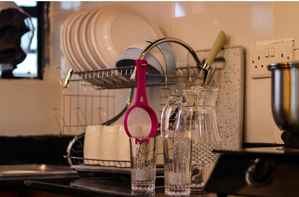 a red scissors sitting on top of a kitchen counter at Ann'sbammyline Serene homes in Ruiru
