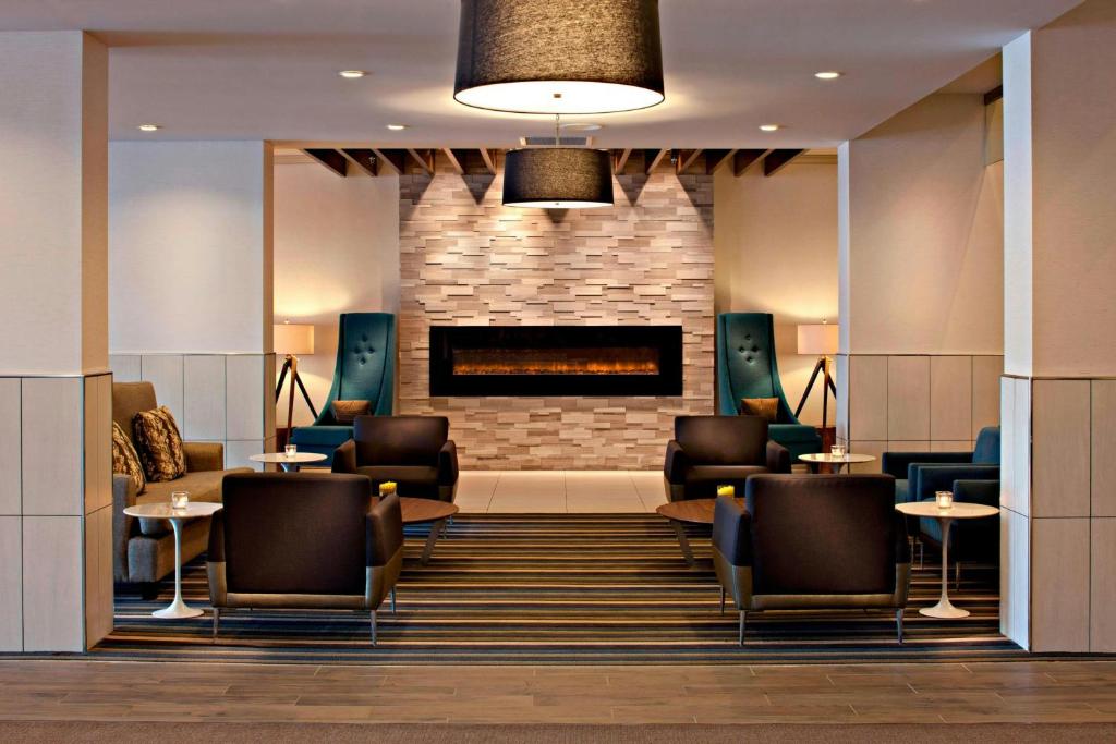 a lobby of a hotel with chairs and a fireplace at Delta Hotels by Marriott Winnipeg in Winnipeg
