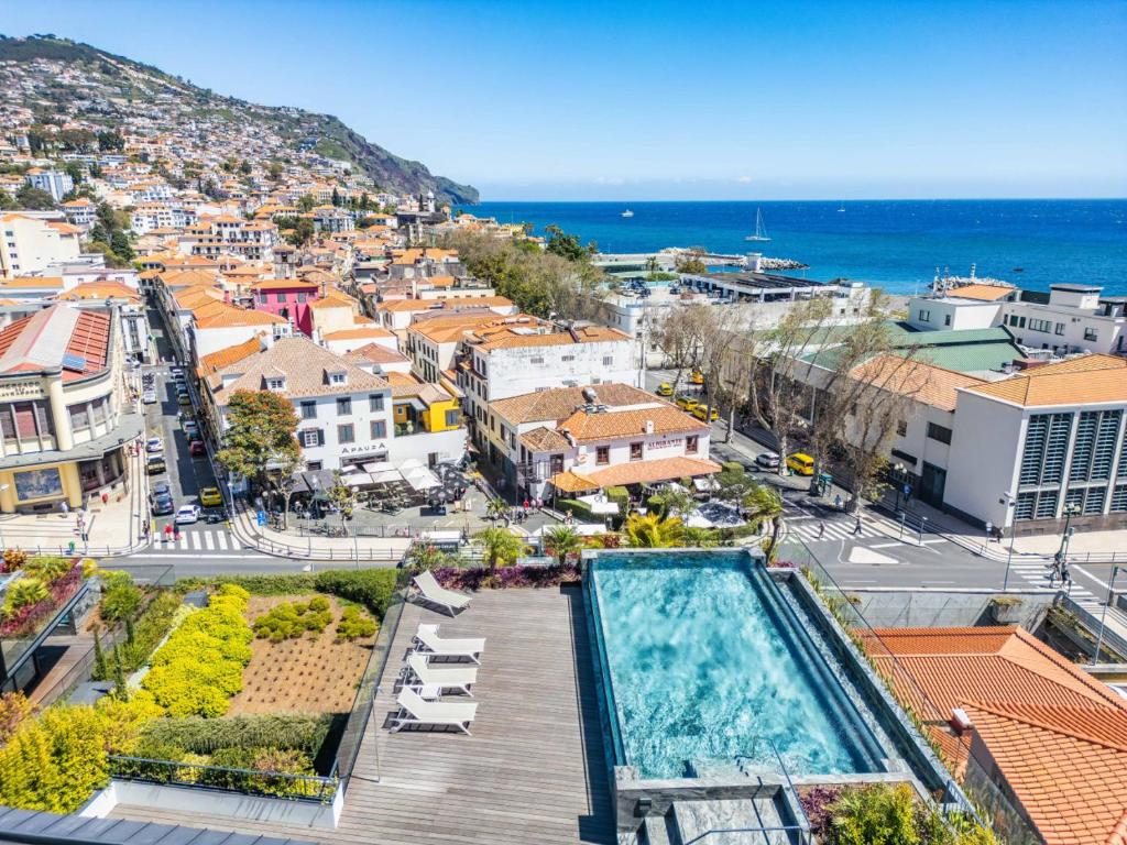 an aerial view of a city with a swimming pool at Luxury 5-Star Stay at Savoy Insular in Funchal